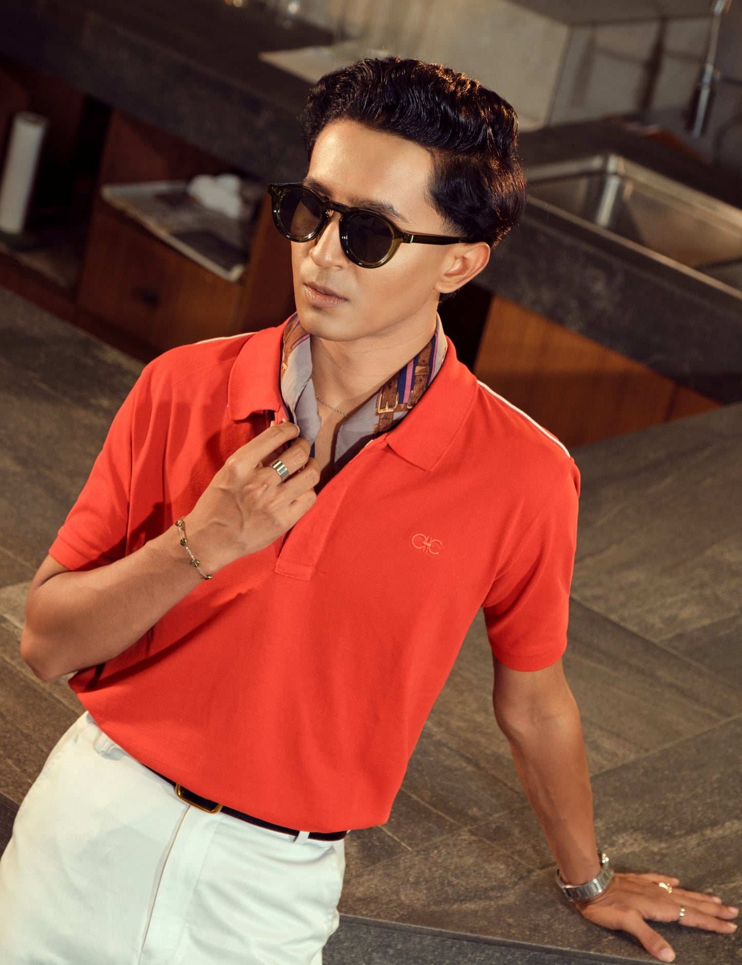 Drip Club Vermilion coral red minimalist polo shirt worn by a model, relaxed unisex fit